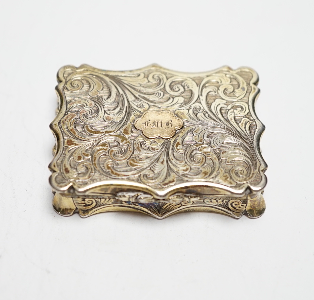 An early Victorian engraved silver gilt vinaigrette, by Nathaniel Mills, Birmingham, 1842, 46mm, with engraved initials.